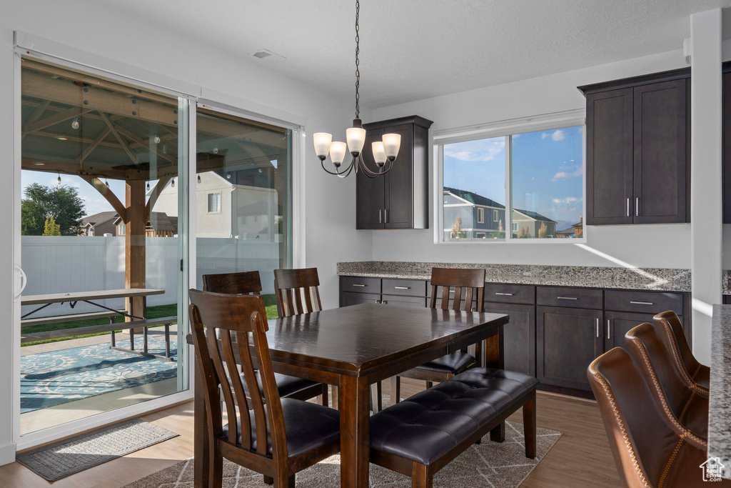 Dining area featuring dark hardwood / wood-style floors and a chandelier