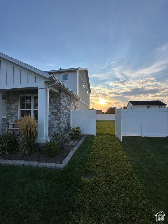 Property exterior at dusk with a yard