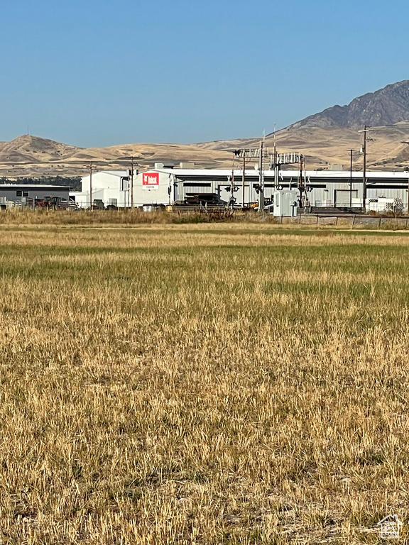 View of yard with a rural view and a mountain view