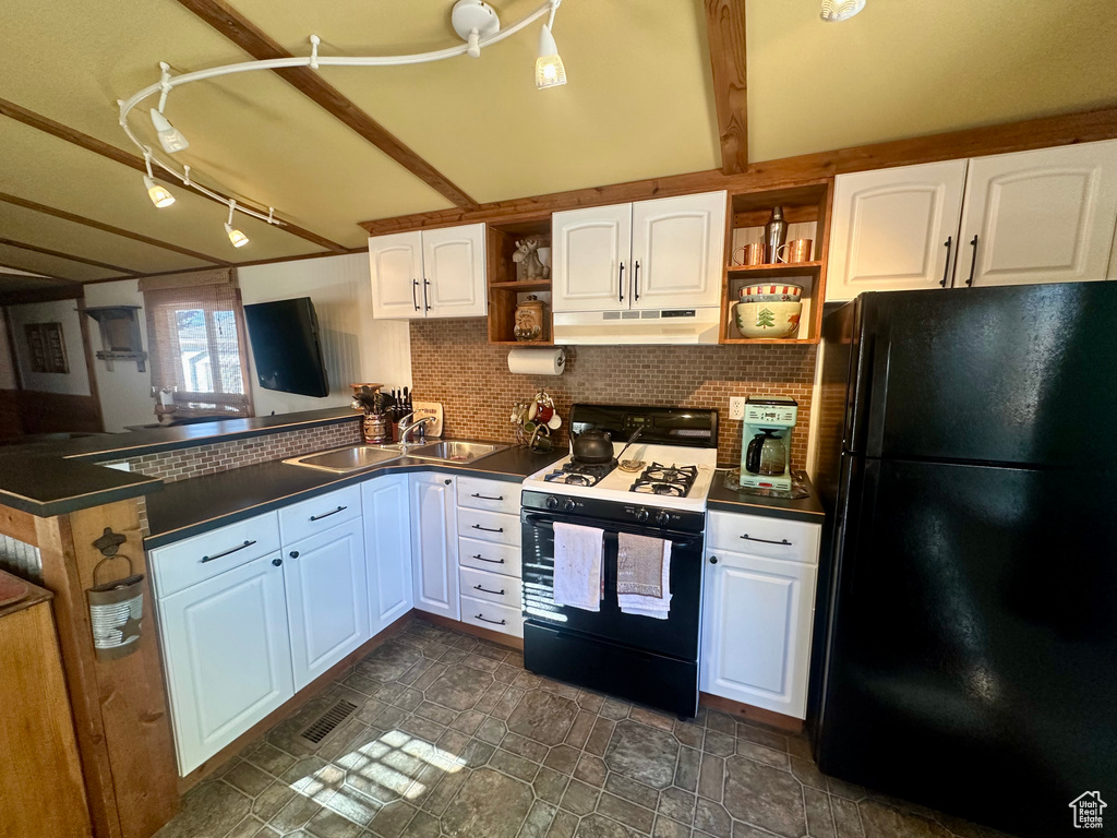 Kitchen with beamed ceiling, sink, kitchen peninsula, white cabinetry, and black appliances