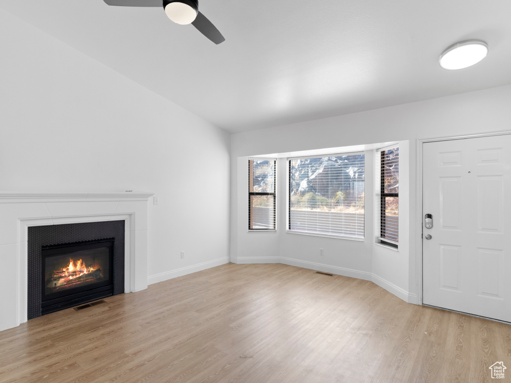 Unfurnished living room with light hardwood / wood-style flooring and ceiling fan