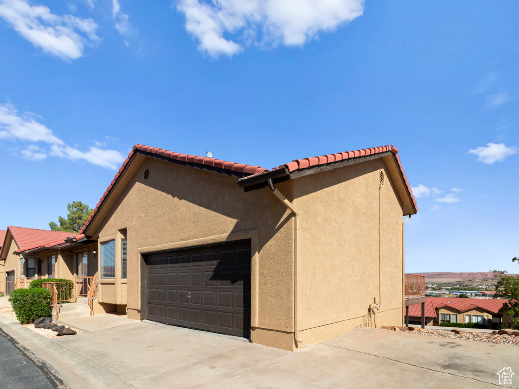 View of property exterior with a garage