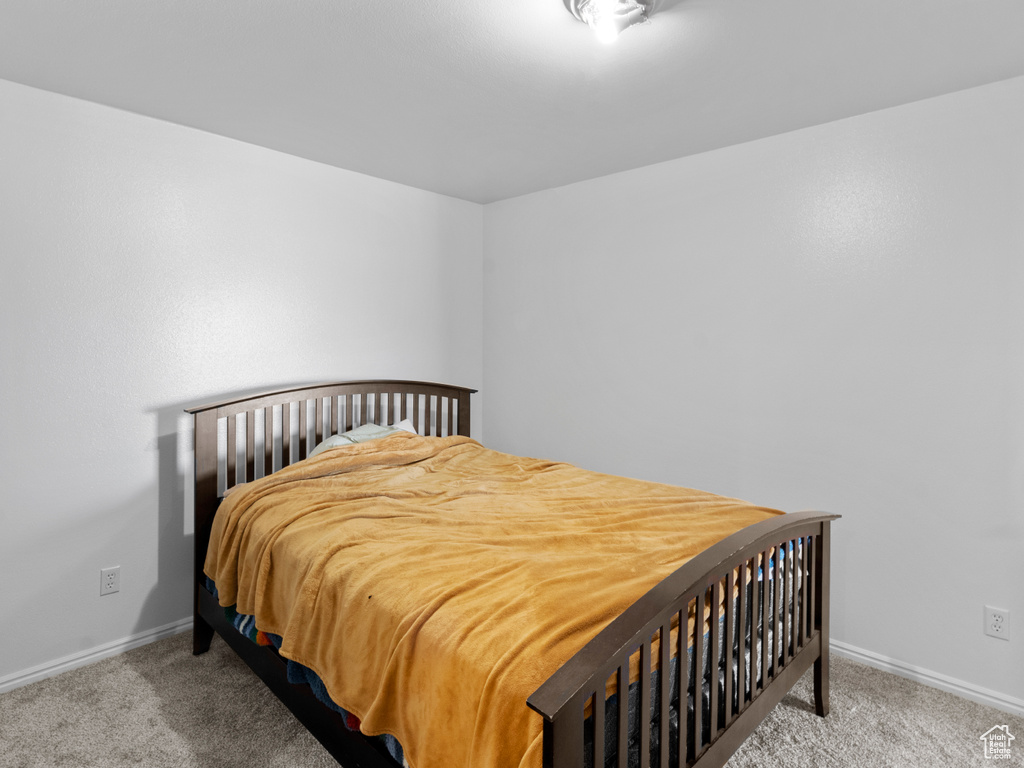 Bedroom featuring light carpet