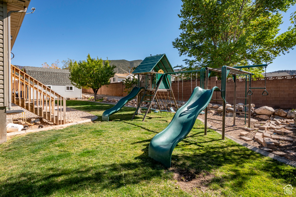 View of playground featuring a lawn