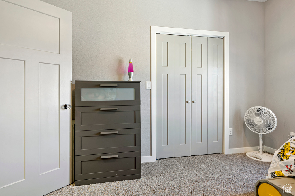 Bedroom featuring light colored carpet