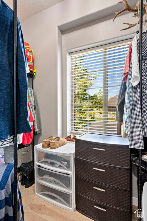 Walk in closet featuring light hardwood / wood-style flooring