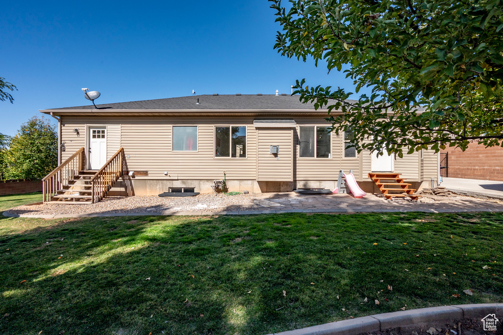 Back of house featuring a yard and a patio