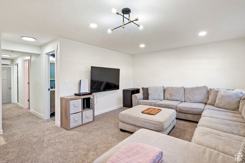 Living room featuring a textured ceiling and carpet flooring