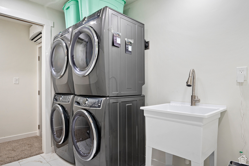 Clothes washing area featuring stacked washer / drying machine