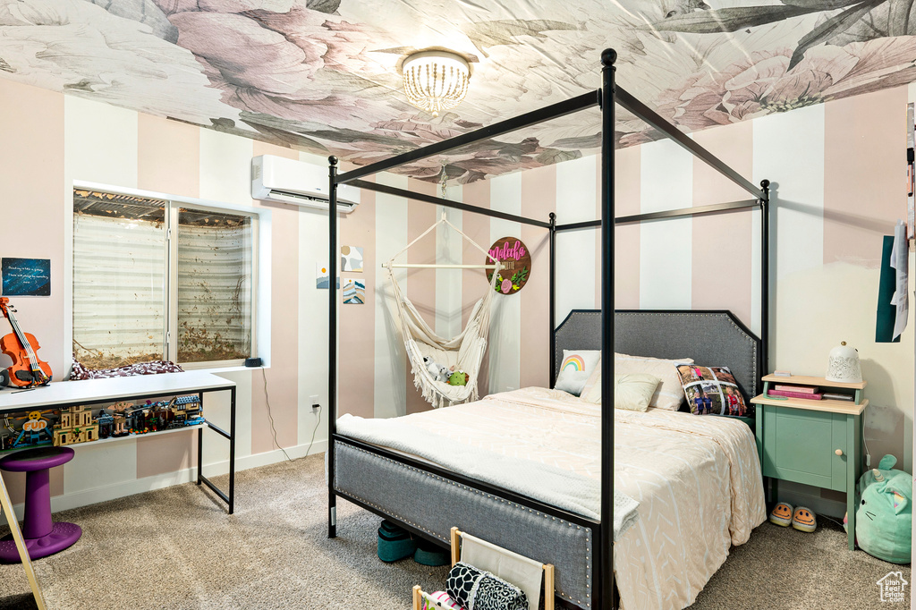 Bedroom featuring a wall unit AC and carpet flooring