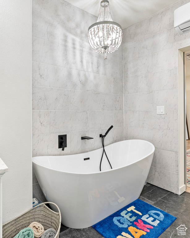 Bathroom with a bathtub, tile walls, a chandelier, tile patterned flooring, and a wall mounted AC