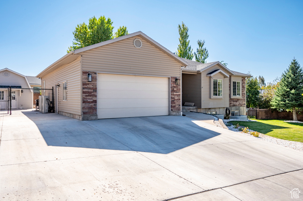 Ranch-style house featuring a front yard and a garage