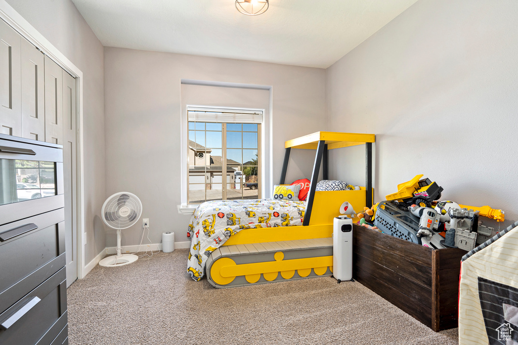 Bedroom featuring carpet and multiple windows