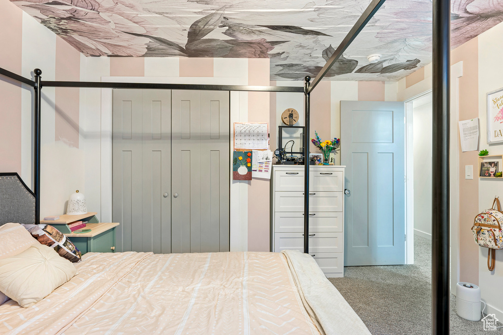 Carpeted bedroom with a closet