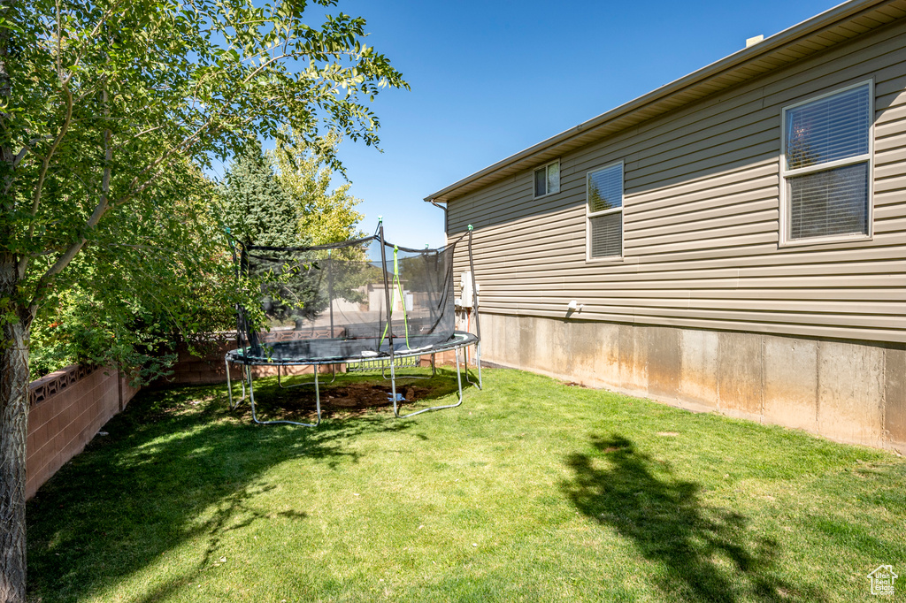 View of yard with a trampoline