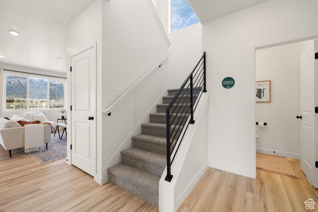 Staircase featuring wood-type flooring