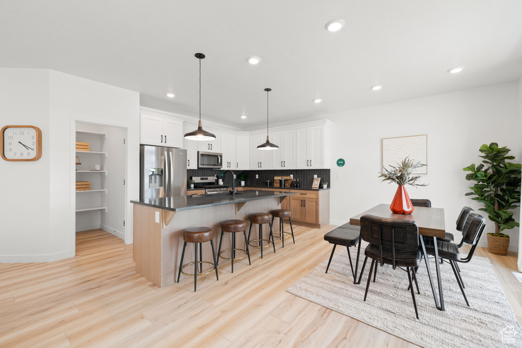 Dining room featuring light wood-type flooring and sink