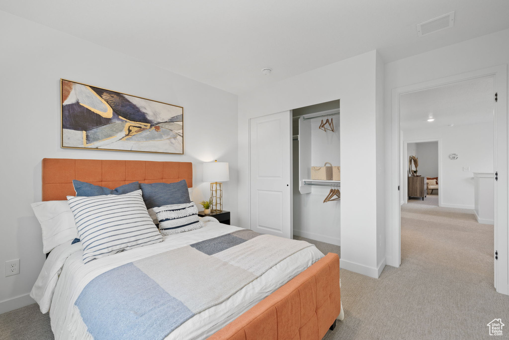 Carpeted bedroom featuring a closet