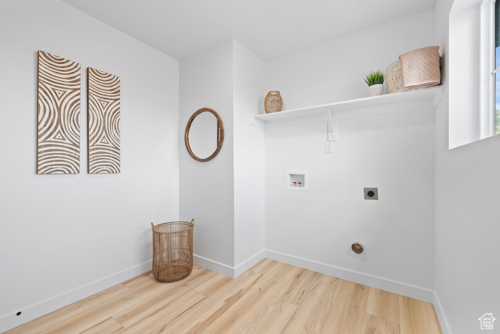 Laundry room with hookup for a washing machine, hardwood / wood-style floors, and hookup for an electric dryer