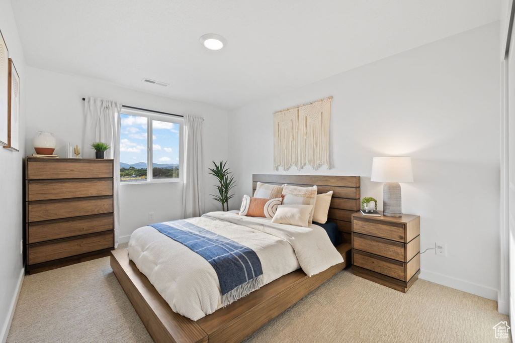 Bedroom with light colored carpet