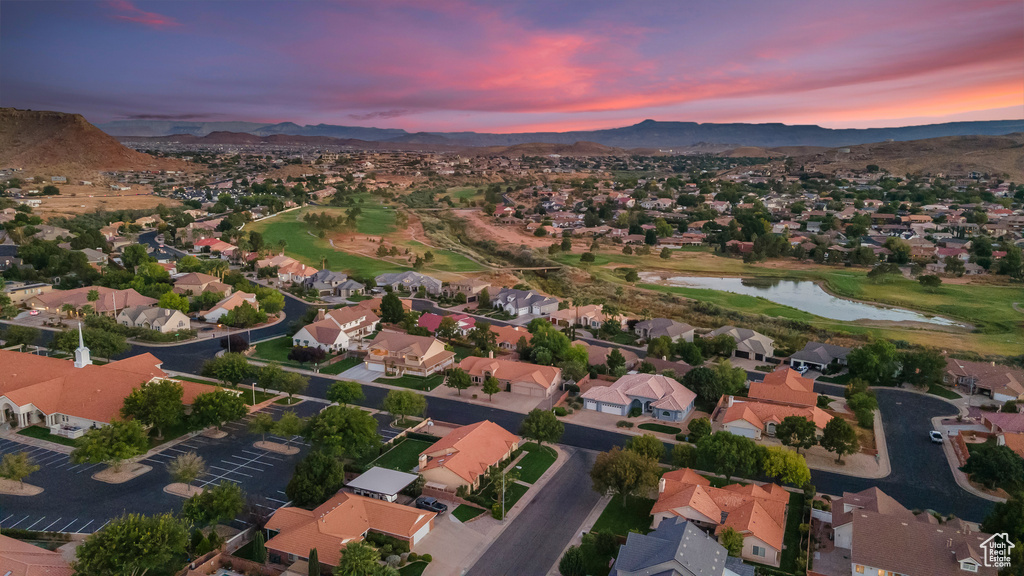 Aerial view at dusk featuring a water and mountain view