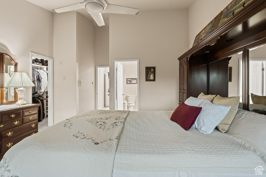 Bedroom featuring connected bathroom, a towering ceiling, ceiling fan, and a closet