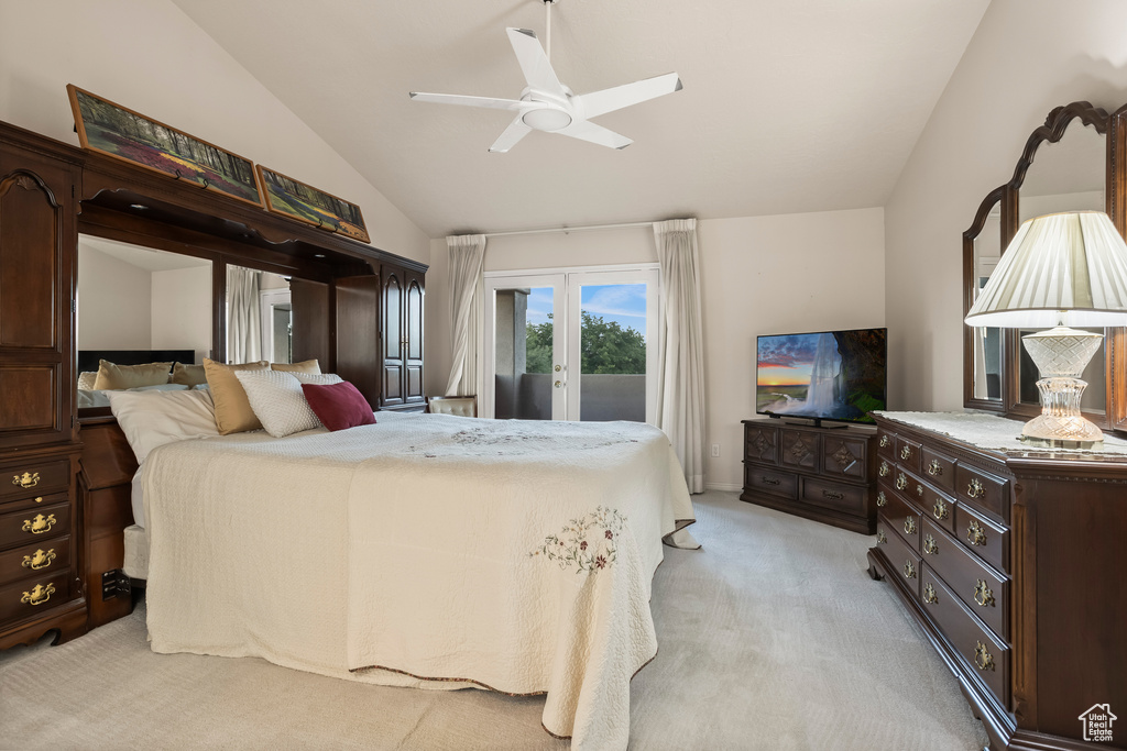 Carpeted bedroom featuring access to outside, vaulted ceiling, ceiling fan, and french doors