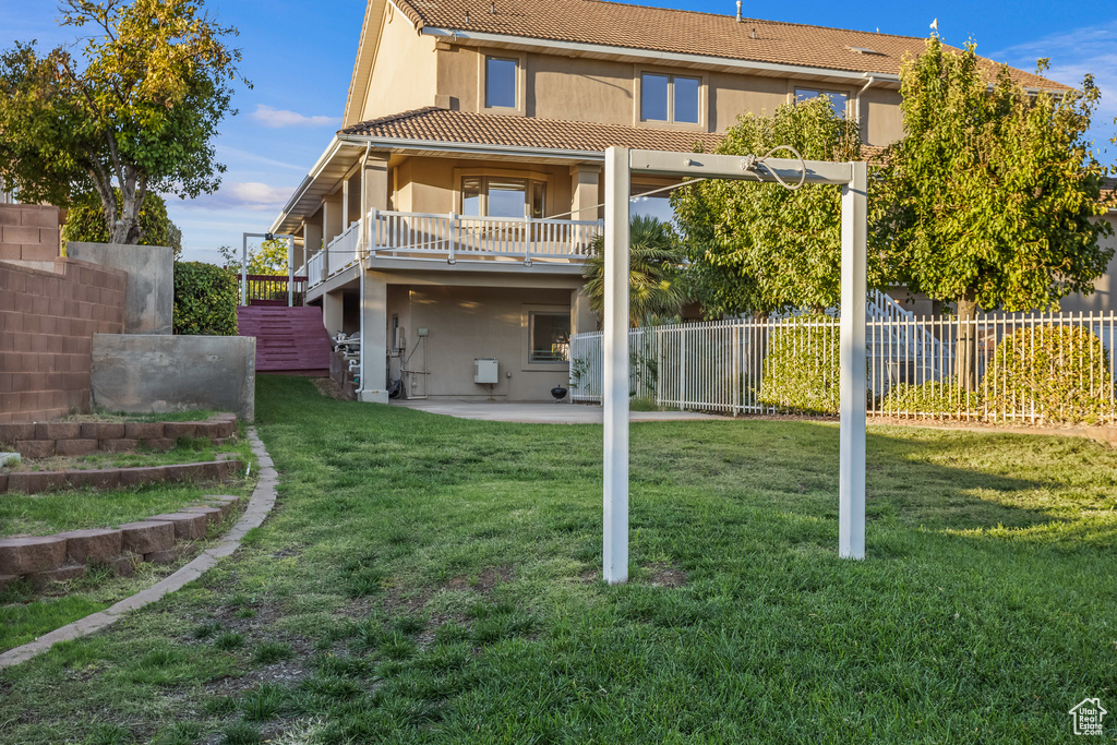 Back of property with a patio area and a yard