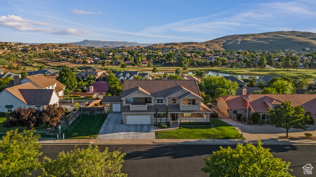 Birds eye view of property featuring a water and mountain view