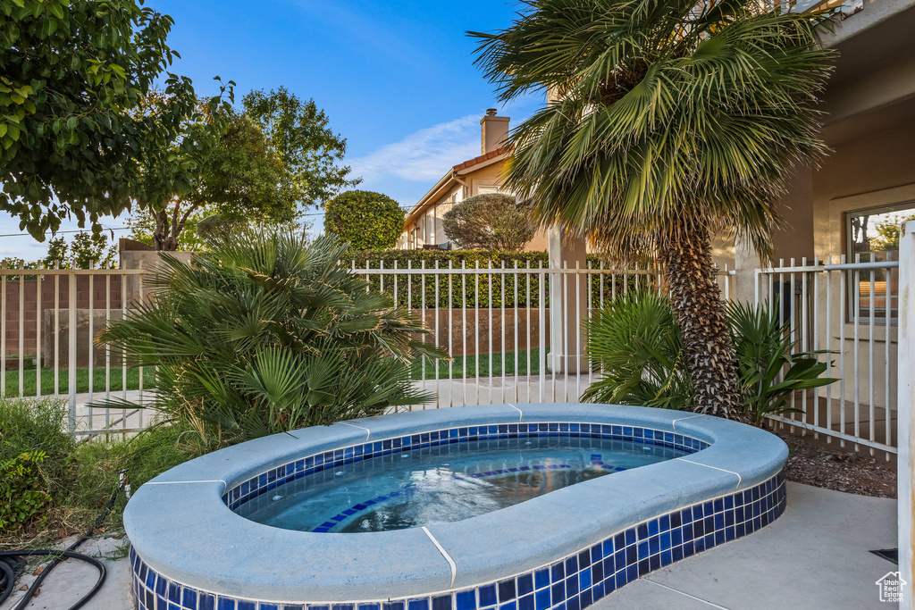 View of swimming pool featuring an in ground hot tub