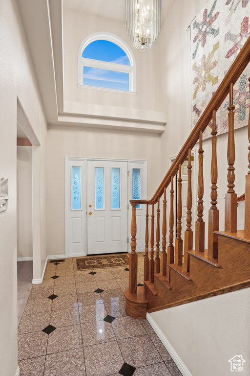 Entrance foyer with a chandelier and a high ceiling