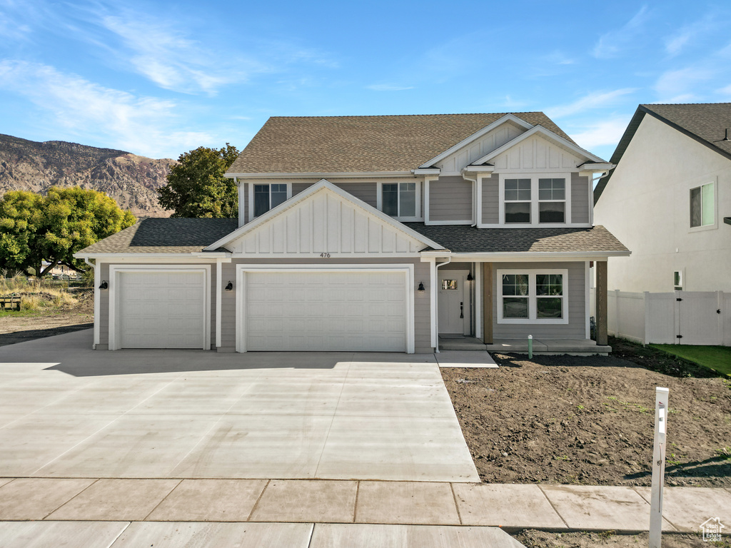 View of front facade with a garage and a mountain view