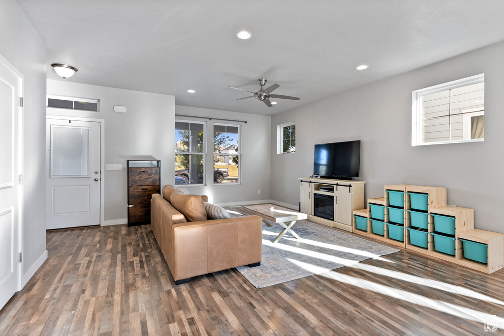 Living room featuring ceiling fan and hardwood / wood-style floors