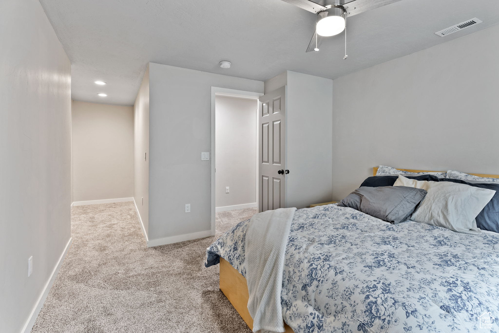 Carpeted bedroom with ceiling fan