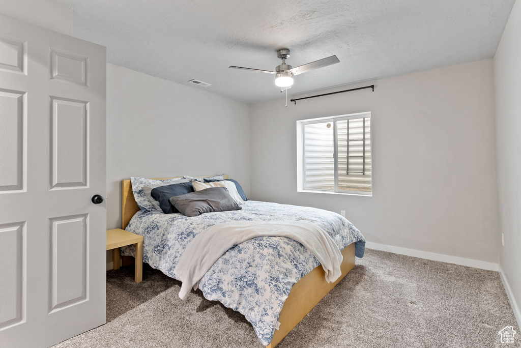 Bedroom with ceiling fan and carpet flooring