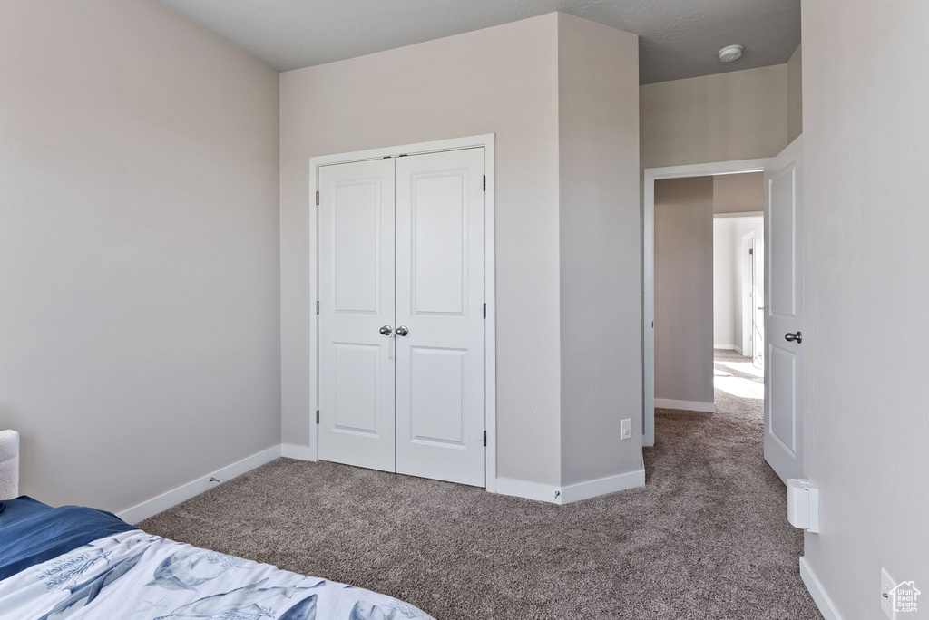 Unfurnished bedroom with carpet floors and a closet