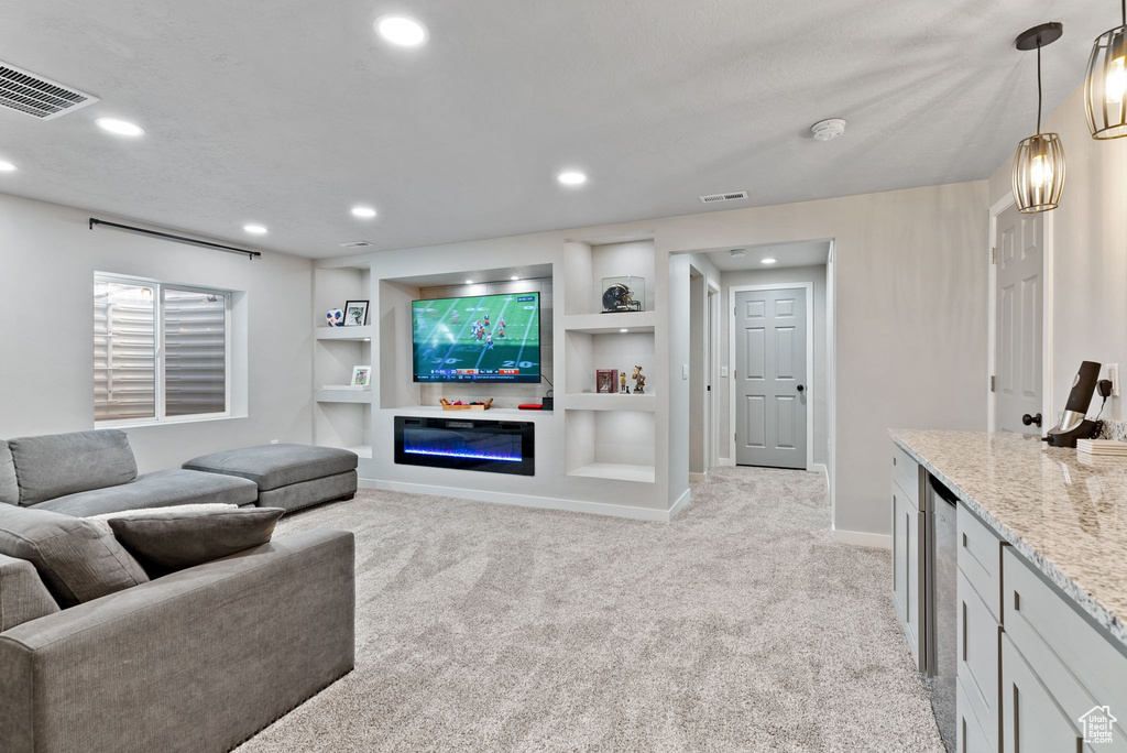 Living room with built in shelves and light colored carpet