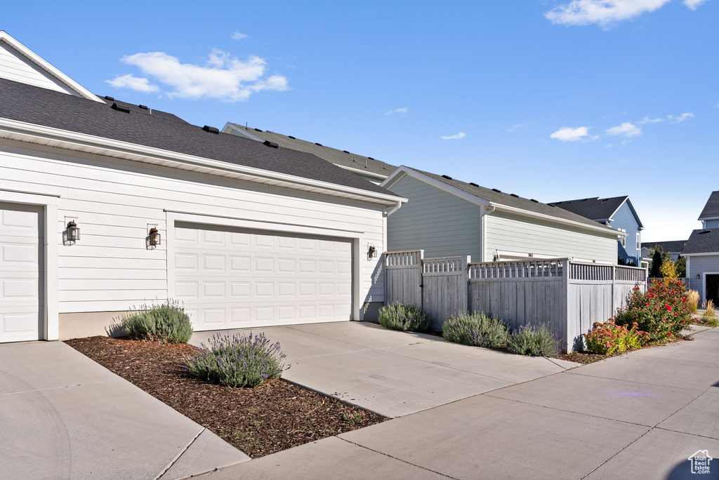 View of property exterior featuring a garage