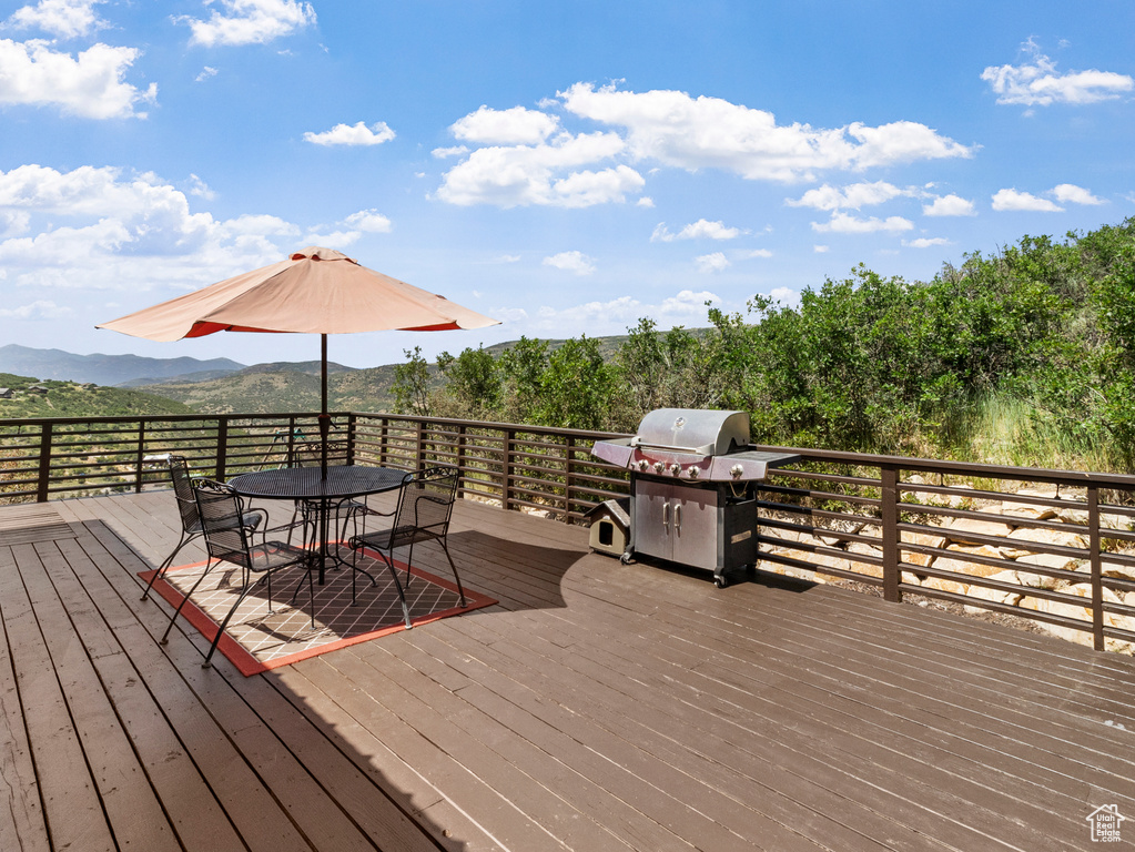 Wooden terrace featuring area for grilling and a mountain view