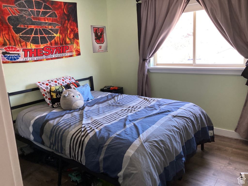 Bedroom with hardwood / wood-style flooring