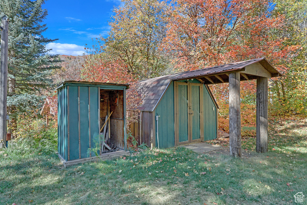 View of outdoor structure featuring a yard