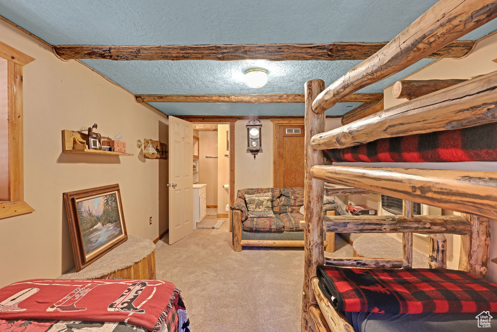 Carpeted bedroom featuring a textured ceiling