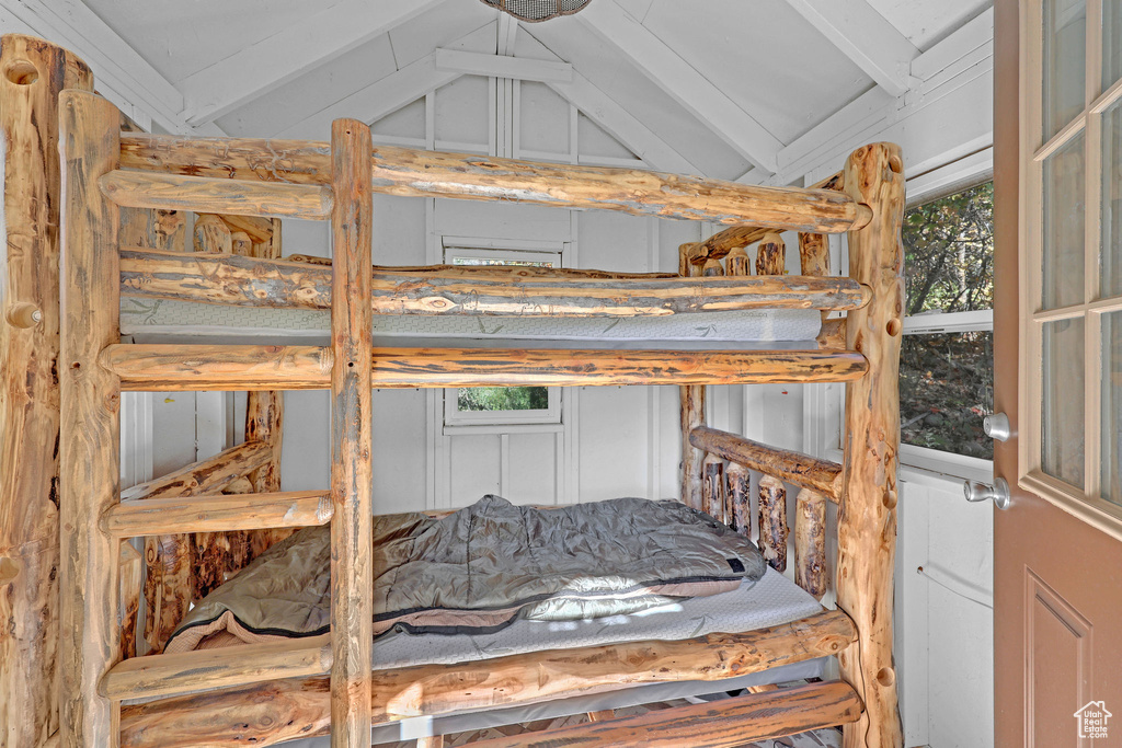 Bedroom featuring lofted ceiling with beams