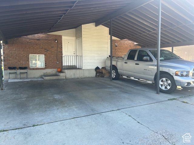 View of parking / parking lot with a carport