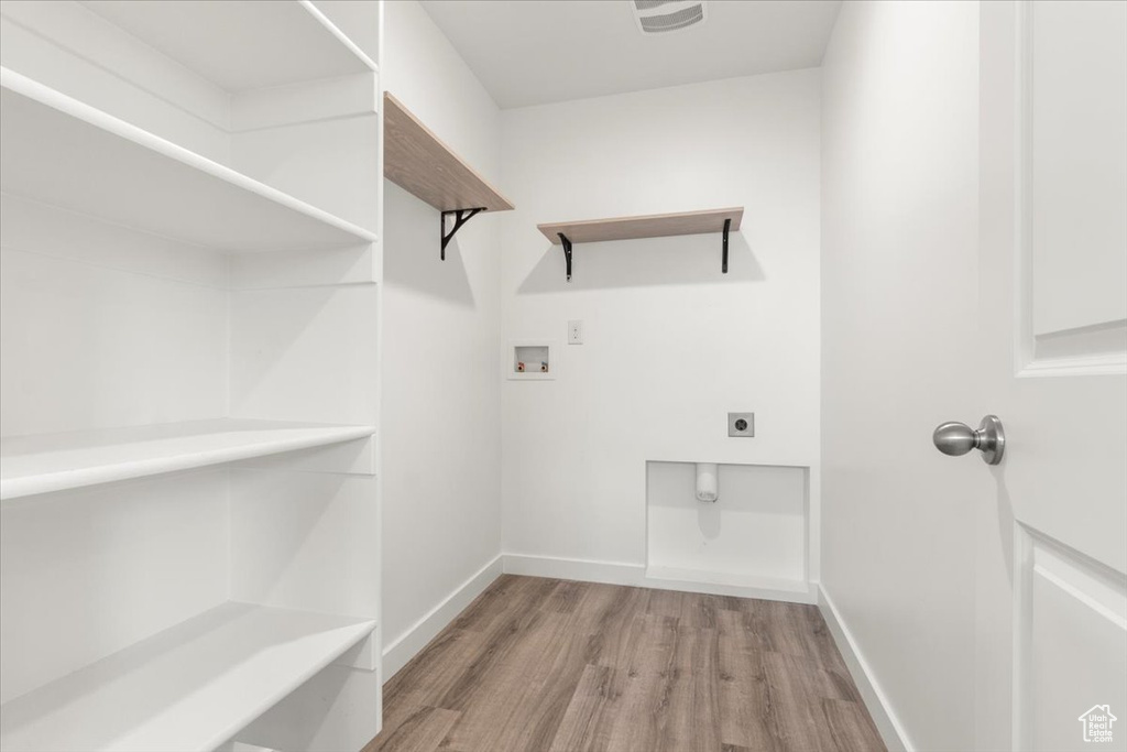 Laundry area featuring washer hookup, hookup for an electric dryer, and light hardwood / wood-style floors