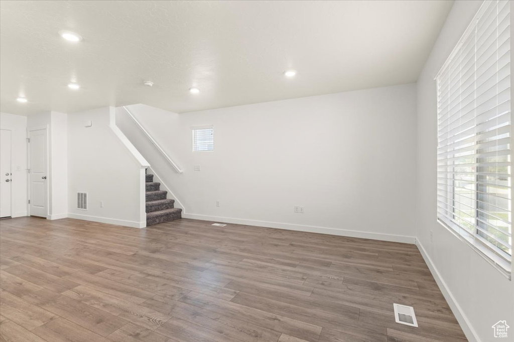 Unfurnished living room featuring wood-type flooring