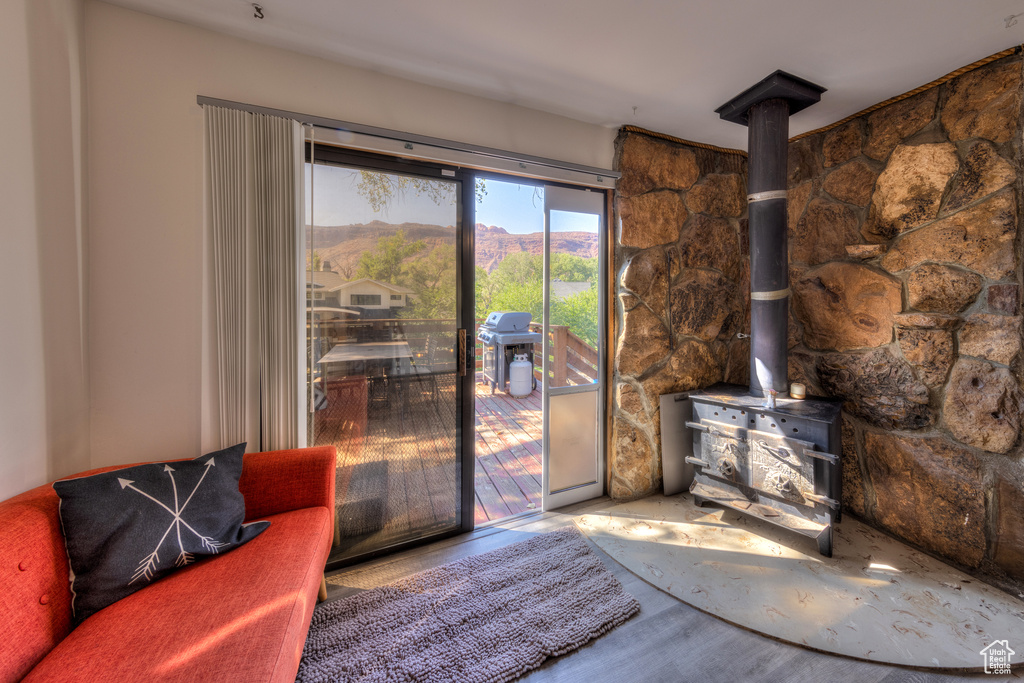 Living room with a mountain view, hardwood / wood-style flooring, and a wood stove