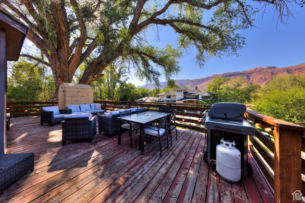 Deck featuring a mountain view and an outdoor living space