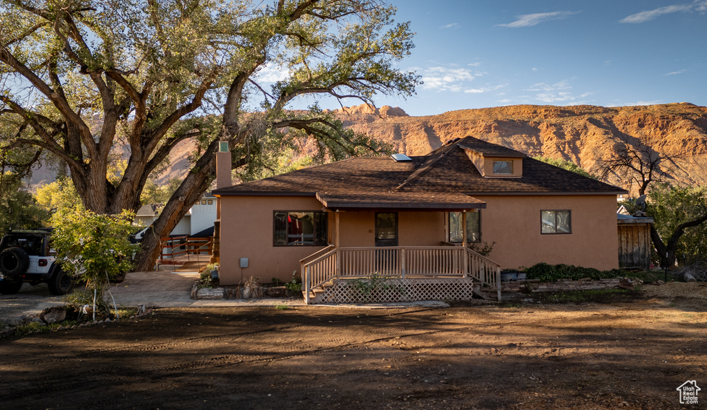View of front of home featuring a mountain view and a porch
