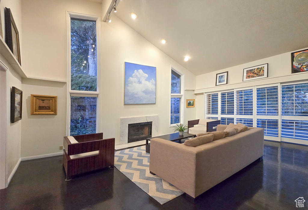 Living room featuring high vaulted ceiling and track lighting